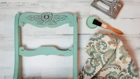 Furniture items being refinished and refreshed with paint and fabric.