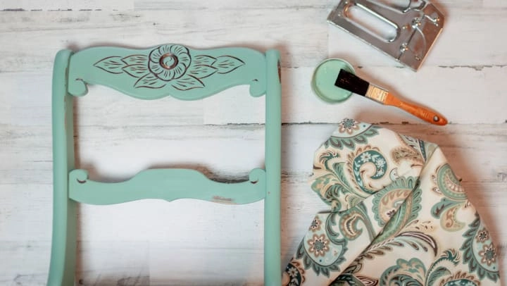 Furniture items being refinished and refreshed with paint and fabric.