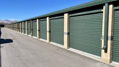 Green doored storage units outside at the Towne Storage Redwood Storage Facility