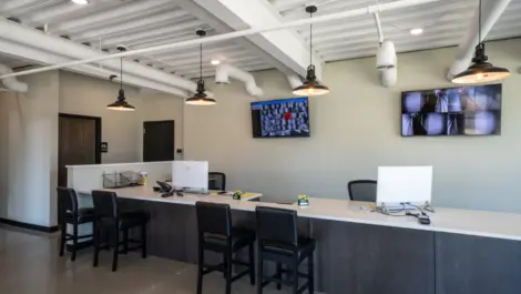 Office area for store manager with security tvs on the wall at Towne Storage-Clinton