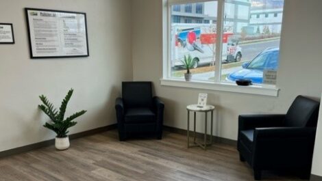 seating area at storage facility in Orem, UT. Two chairs, a table and a window view of the truck rental company