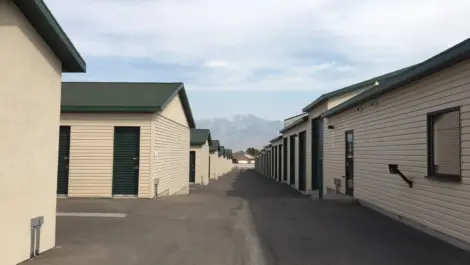 Rows of exterior green doored storage units at a Towne Storage Facility