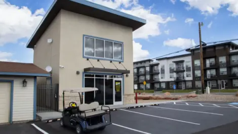 Store front to Towne Storage - Daniels Rd. with apartments in the background. Golf cart parked out front