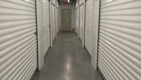 Interior hallway of a storage facility with roll up doors