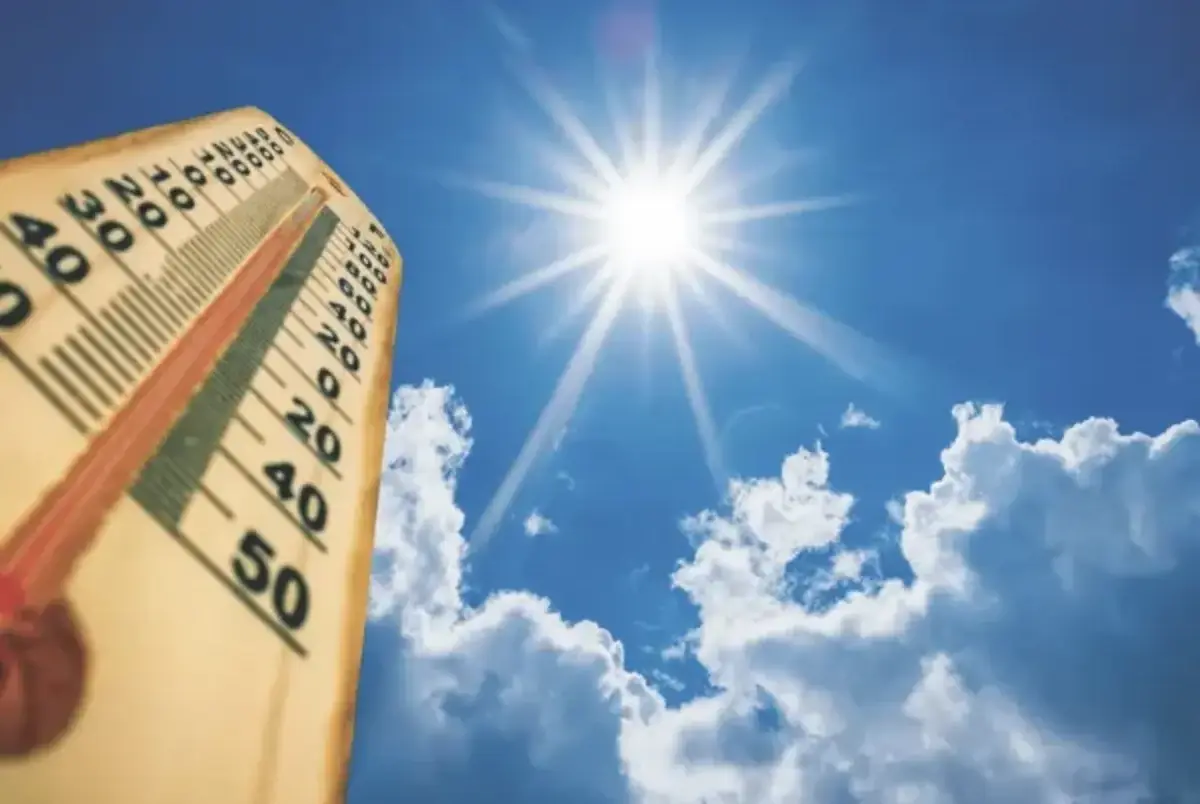 Temperature gage and view of sky with sunlight